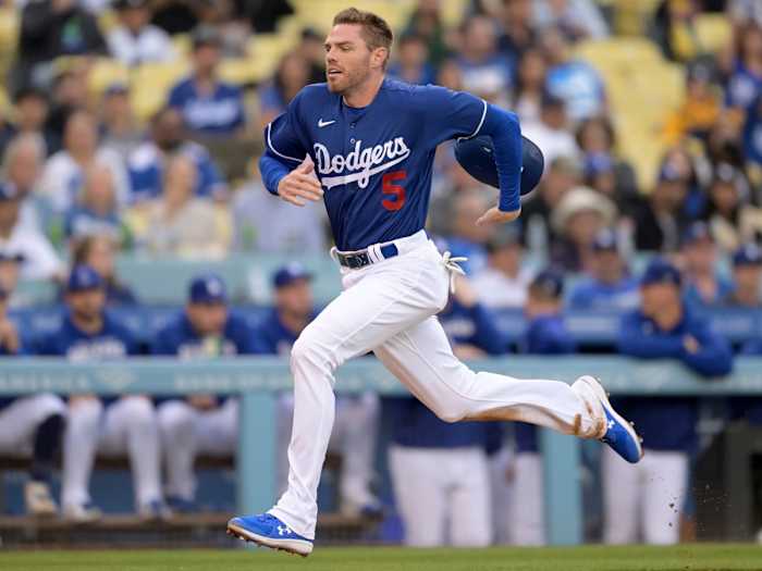 Apr 4, 2022; Los Angeles, California, USA; Los Angeles Dodgers first baseman Freddie Freeman (5) scores a run from third base in the first inning against the Los Angeles Angels at Dodger Stadium.